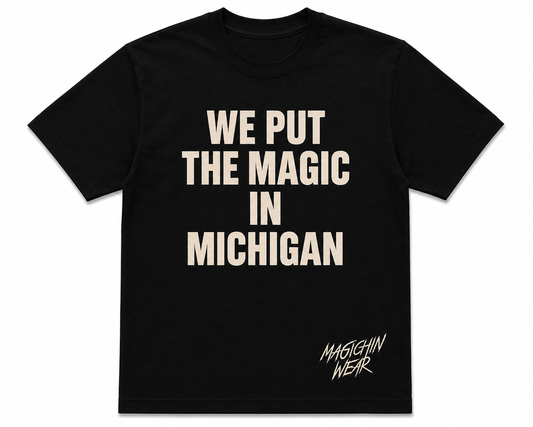 Black t-shirt with 'WE PUT THE MAGIC IN MICHIGAN' text on a white background